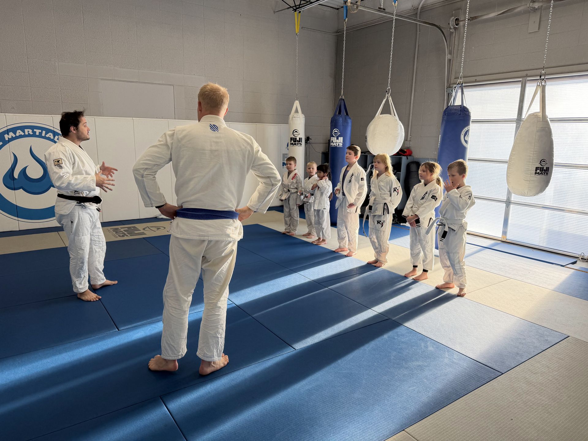 Kids lined up with their coaches at Stoic Martial Arts in Chanhassen, Minnesota